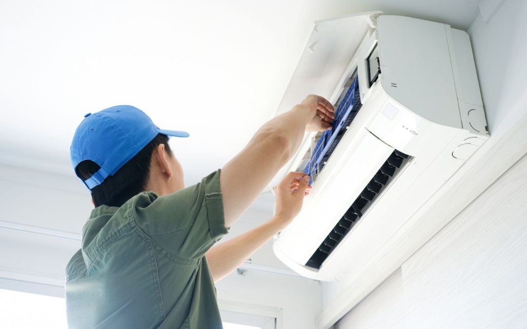 Air conditioning technician maintaining an indoor mini split system in Spanish Fork, UT