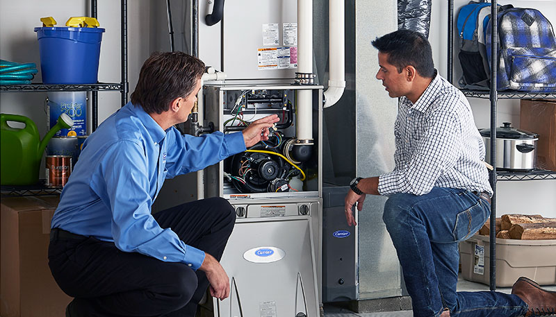 HVAC technician evaluating a furnace for repair or replacement in Spanish Fork