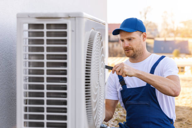 HVAC technician servicing an outdoor air conditioning unit in Spanish Fork