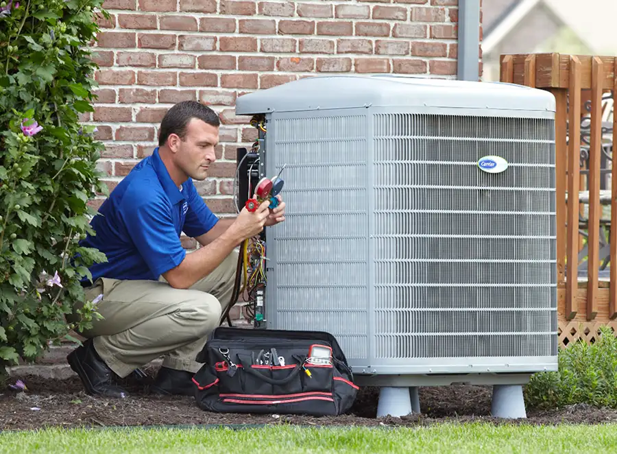 HVAC technician inspecting an outdoor air conditioning unit in Spanish Fork