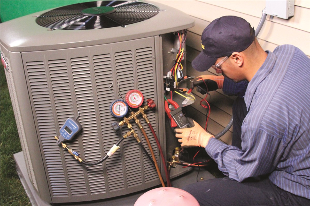 HVAC technician testing an outdoor air conditioning unit in Spanish Fork