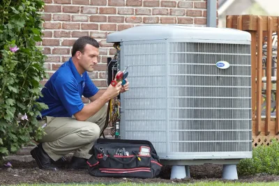 design-air-heating-and-air-conditioning-decatur-il-05 – Copy HVAC technician inspecting an outdoor air conditioning unit in Spanish Fork, UT